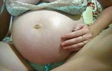 Preggo girl playing with her belly on webcam